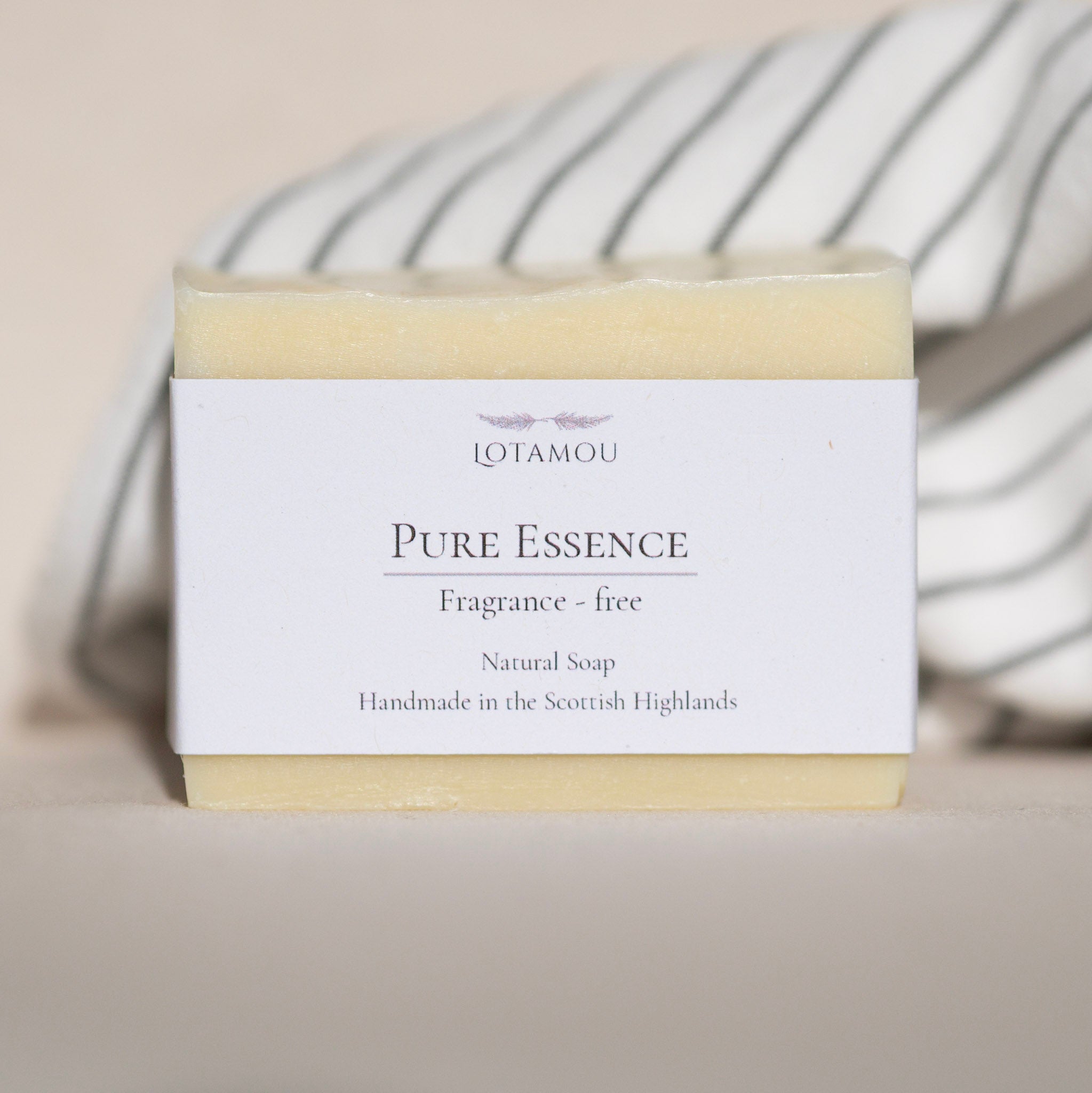 Box of Lotamou Pure Essence natural soap on a neutral background