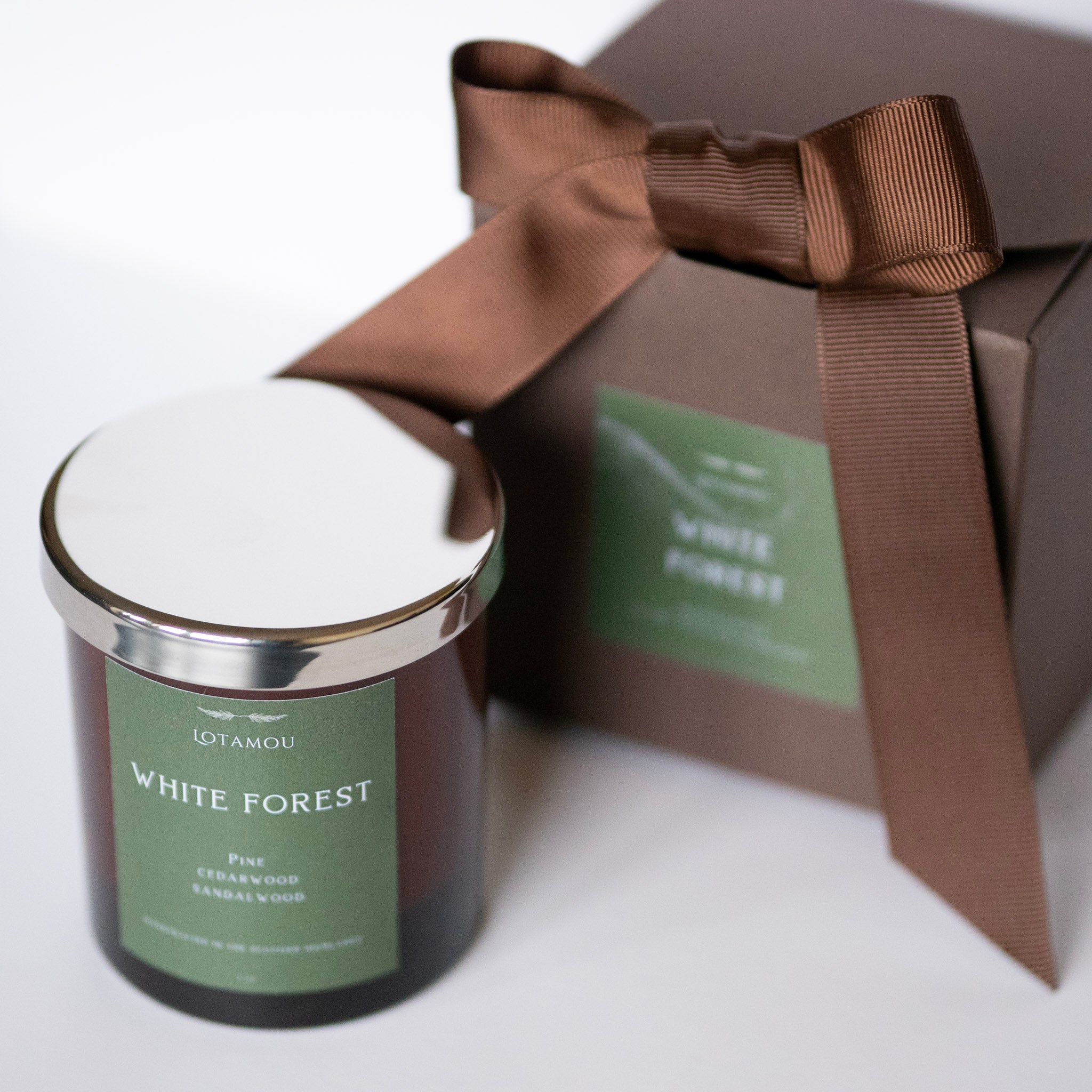 Candle labeled 'White Forest' with a matching gift box on a white background