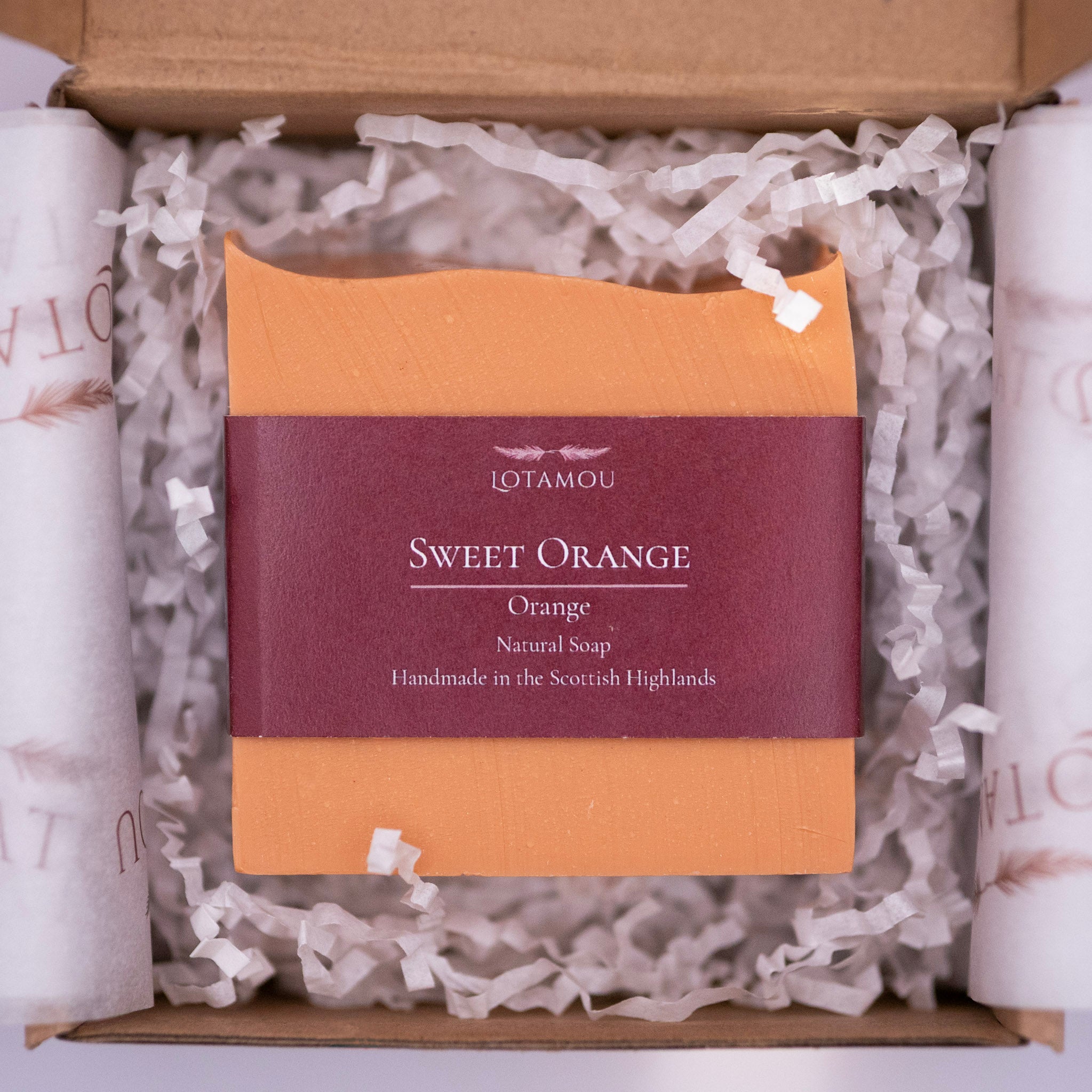 LOTAMOU Sweet Orange soap bar in a box with white tissue paper