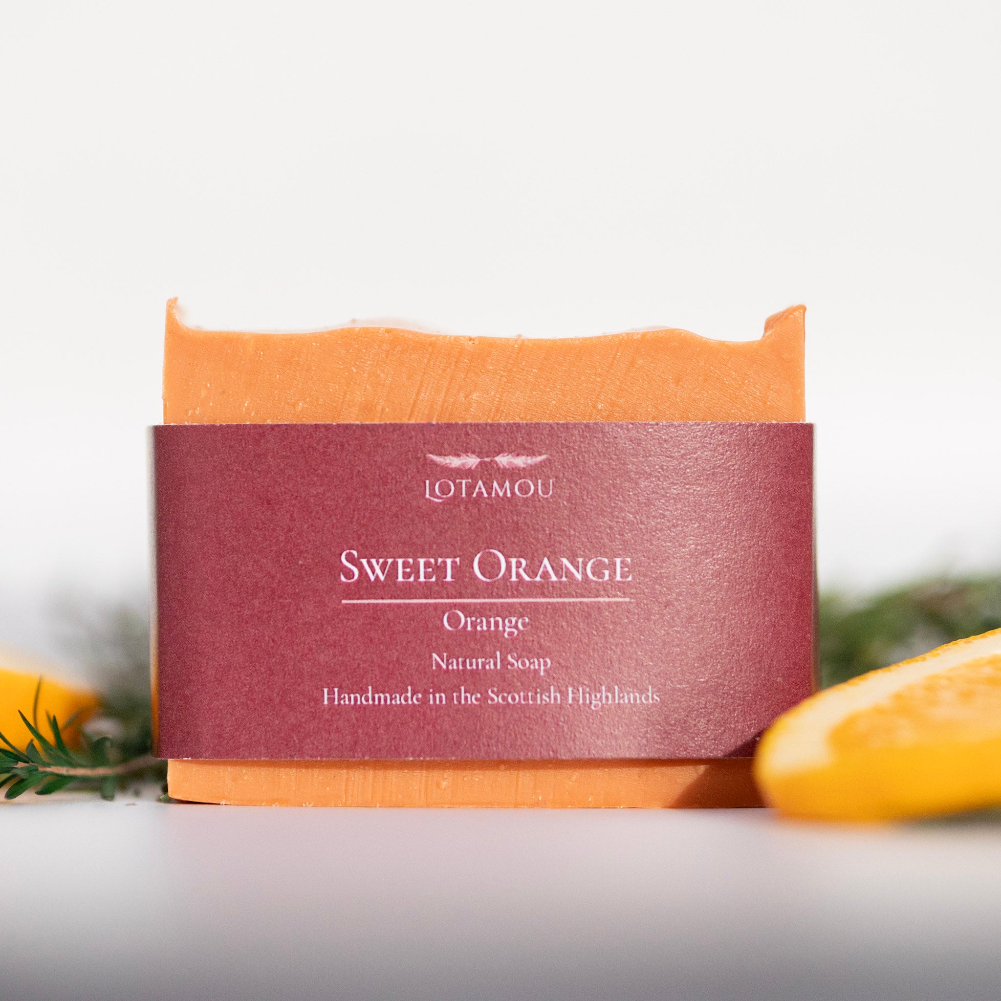 Bar of soap with a maroon label on a white background