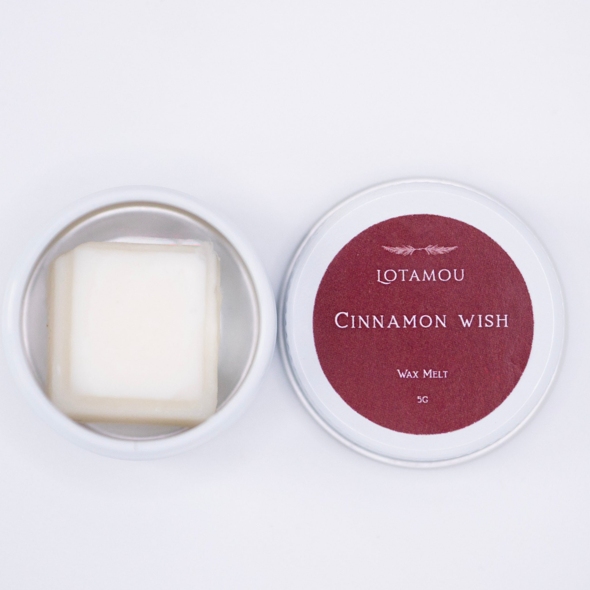 Cinnamon wish wax melt in a tin with 'LOTAMOU' branding on a white background