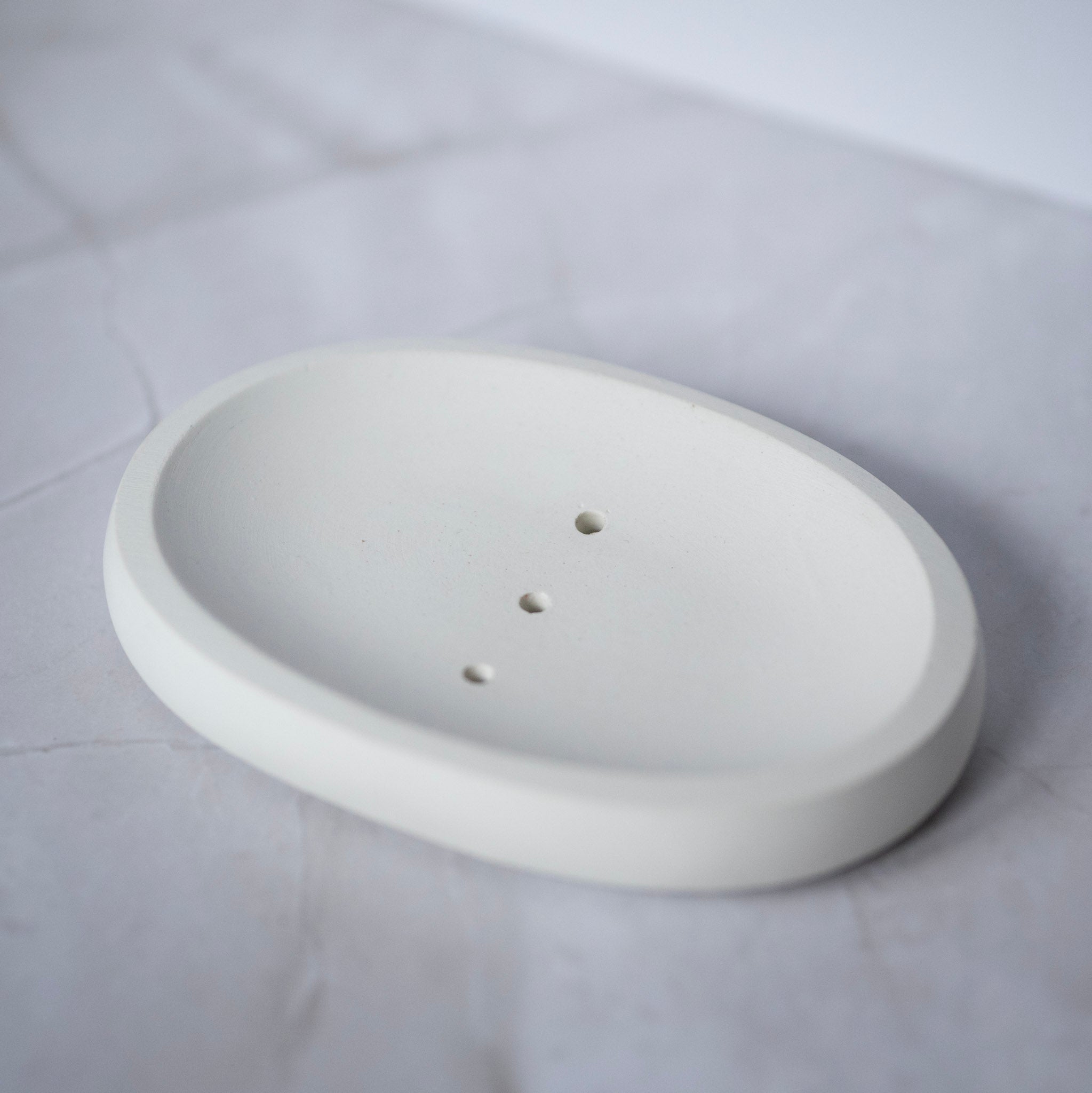 White ceramic soap dish on a white background